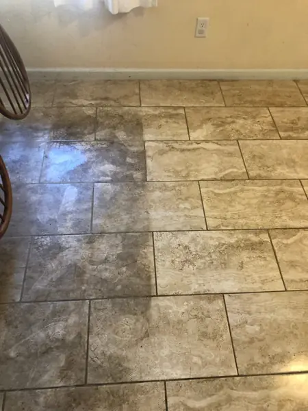Tile floor with a sharp line between cleaned and uncleaned sections